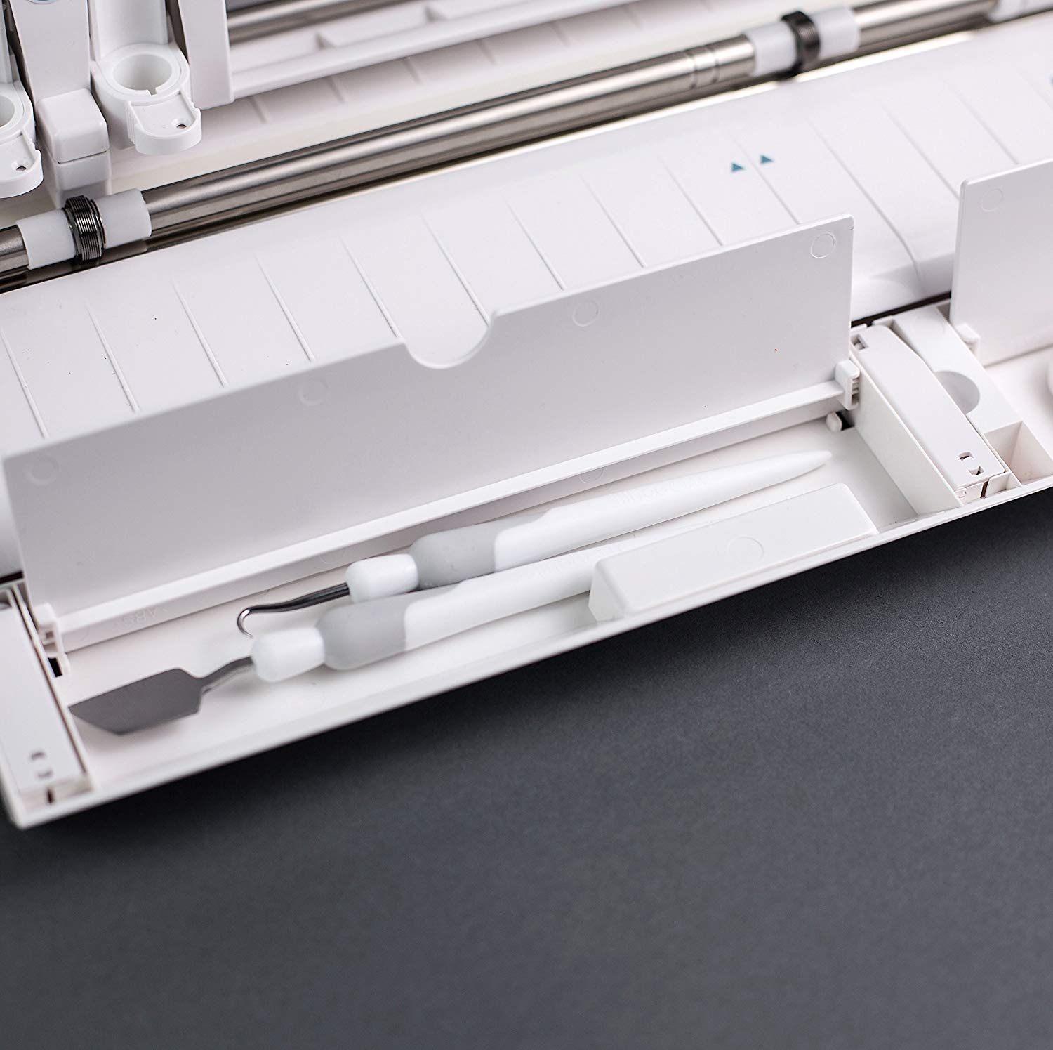 Silhouette Cameo 3 has two hidden compartments. A long one for pens and tools and a short one for pen blades.