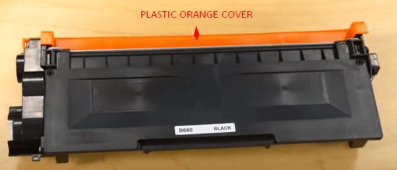 orange plastic cover on toner cartridge