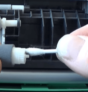  Cleaning paper feed roller's shaft using a Q-tip.